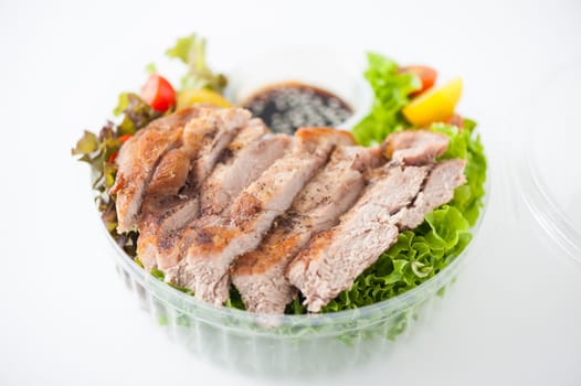 Grilled pork and teriyaki sauce (Japanese sweet sauce) cooked by clean food concept with salad in lunch box