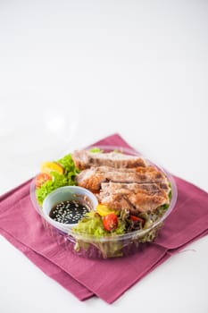 Grilled pork and teriyaki sauce (Japanese sweet sauce) cooked by clean food concept with salad in lunch box