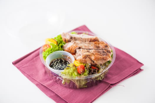 Grilled pork and teriyaki sauce (Japanese sweet sauce) cooked by clean food concept with salad in lunch box