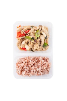 Stir freid basil with chicken breast and Termitomyces cooked by clean food concept with brown rice in lunch box isolated on white background with clipping path