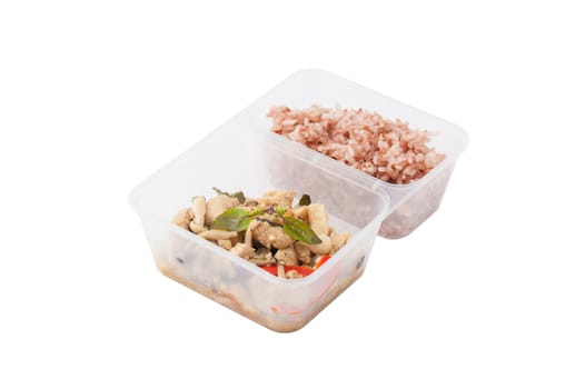 Stir freid basil with chicken breast and Termitomyces cooked by clean food concept with brown rice in lunch box isolated on white background with clipping path