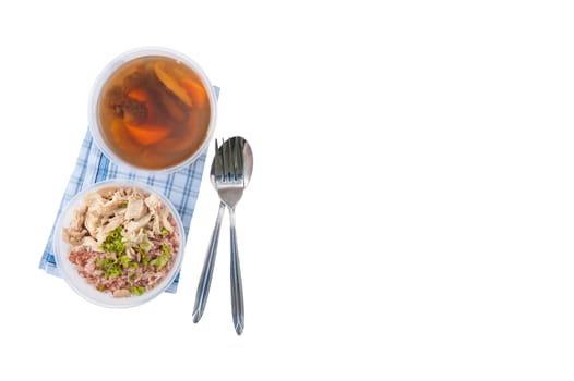 Brown rice gruel with chicken breast with vegetables soup cooked by clean food concept in separate lunch box isolated on white background