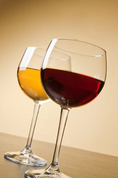 red and white wine glasses on table on golden background