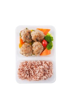 Thai style fried pork ball cooked by clean food concept with vegetables and brown rice in lunch box isolated on white background
