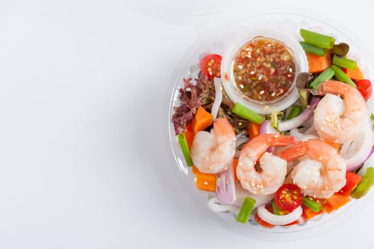 Thai spicy salad with shrimps cooked by clean food concept in lunch box on white table