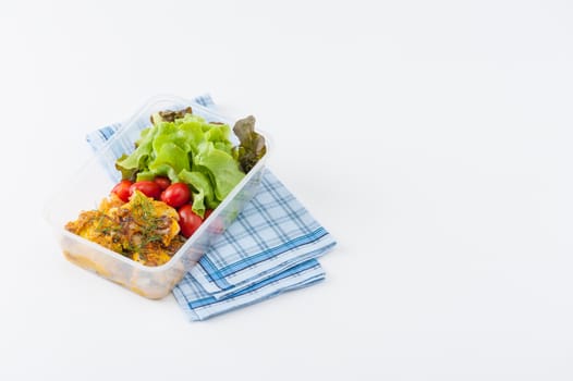 Pangasius fish with mayo mustard sauce cooked by clean food concept and salad in lunch box on white table