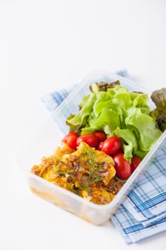 Pangasius fish with mayo mustard sauce cooked by clean food concept and salad in lunch box on white table