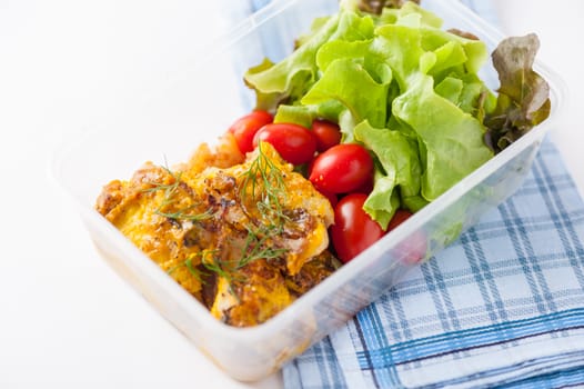 Pangasius fish with mayo mustard sauce cooked by clean food concept and salad in lunch box on white table