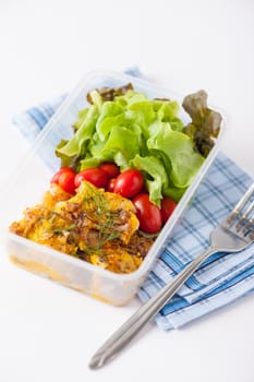 Pangasius fish with mayo mustard sauce cooked by clean food concept and salad in lunch box on white table