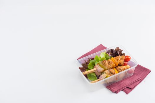 Chicken breast barbecue cooked by clean food concept and vegetables in lunch box on white table