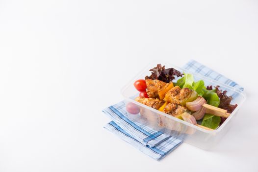 Chicken breast barbecue cooked by clean food concept and vegetables in lunch box on white table