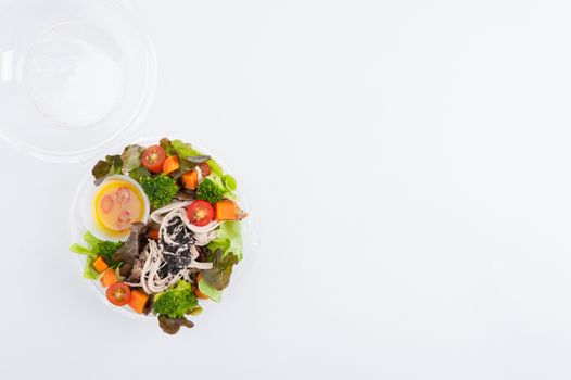 Chicken breast salad with honey thyme sauce cooked by clean food concept in lunch box on white table