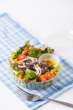 Chicken breast salad with honey thyme sauce cooked by clean food concept in lunch box on white table
