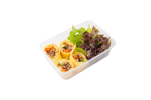 Thai spicy egg rolls (Fresh spring rolls, Kuay Teaw Lui Suan but use egg replace to rice sheet) with tofu, minced pork and vegetables cooked by clean food concept in lunch box isolated on white background