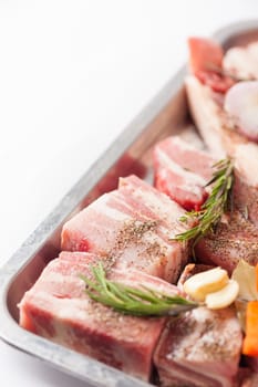 Ingredients for making pork stock soup in steel tray on white table