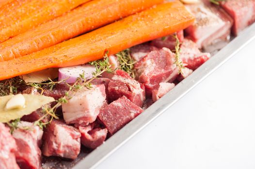 Ingredients for making pork stock soup in steel tray on white table