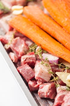 Ingredients for making pork stock soup in steel tray on white table