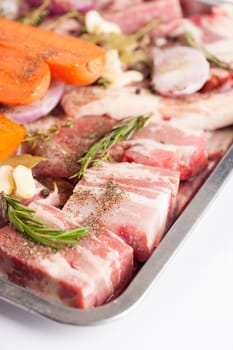 Ingredients for making pork stock soup in steel tray on white table