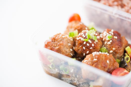 Tsukune (Japanese chicken meatballs) cooked by clean food concept with brown rice in lunch box