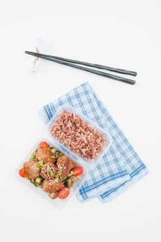 Tsukune (Japanese chicken meatballs) cooked by clean food concept with brown rice in lunch box