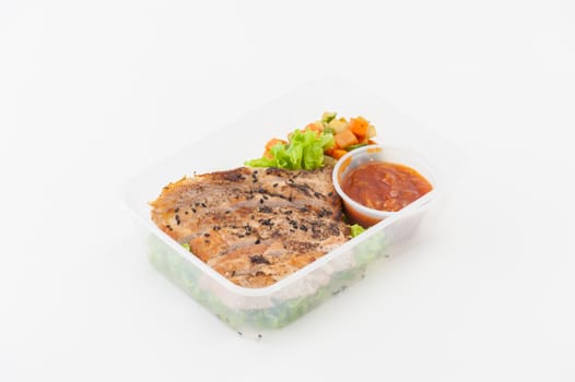 Roasted pork with three flavoured (sweet, sour, spicy) sauce cooked by clean food concept with vegetables in lunch box