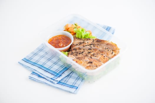 Roasted pork with three flavoured (sweet, sour, spicy) sauce cooked by clean food concept with vegetables in lunch box