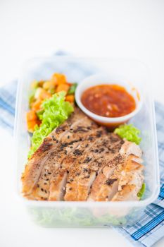 Roasted pork with three flavoured (sweet, sour, spicy) sauce cooked by clean food concept with vegetables in lunch box