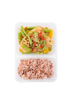 Pangasius fish fried with chili and vegetables cooked by clean food concept with brown rice in lunch box on white table