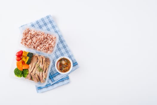 Roasted pork tenderloin with vegetables cooked by clean food concept with brown rice and Northern Thai local sauce on white table