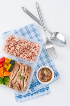 Roasted pork tenderloin with vegetables cooked by clean food concept with brown rice and Northern Thai local sauce on white table
