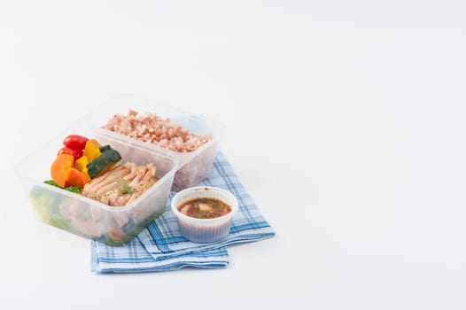Roasted pork tenderloin with vegetables cooked by clean food concept with brown rice and Northern Thai local sauce on white table