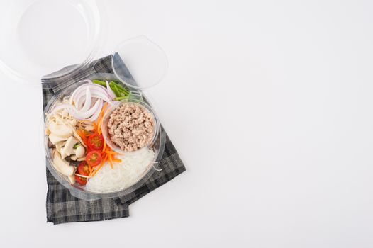Thai spicy salad with minced pork, mushroom, vegetables and vermicelli cooked by clean food concept on white table