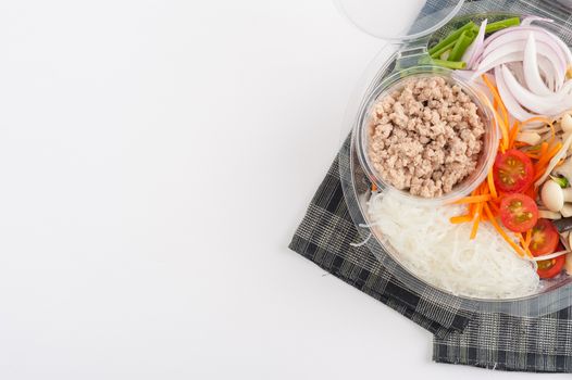 Thai spicy salad with minced pork, mushroom, vegetables and vermicelli cooked by clean food concept on white table
