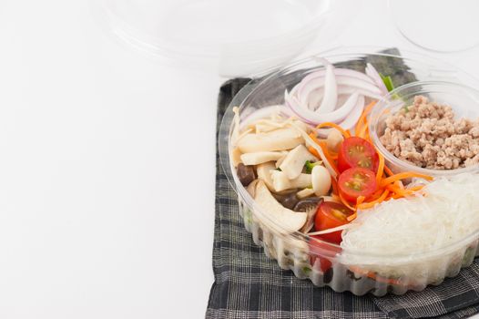 Thai spicy salad with minced pork, mushroom, vegetables and vermicelli cooked by clean food concept on white table
