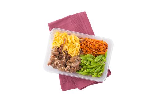 Bibimbub in clean food style. Brown rice with roasted pork, egg, and vegetables isolated on white background with clipping path