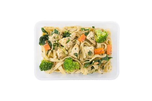 Fettuccine pesto sauce with spinach, grilled fish and vegetables cooked by clean food concept in lunch box isolated on white background with clipping path