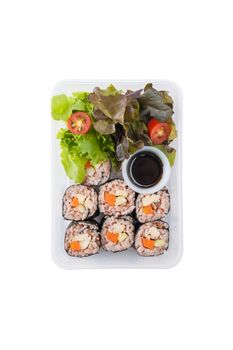 Japanese style brown rice maki with grilled chicken, grilled pork, and grilled tofu cooked by clean food concept in lunch box isolated on white background with clipping path