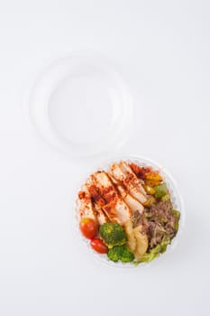 Roasted chicken with paprika powder cooked by clean food concept and salad in lunch box on white table