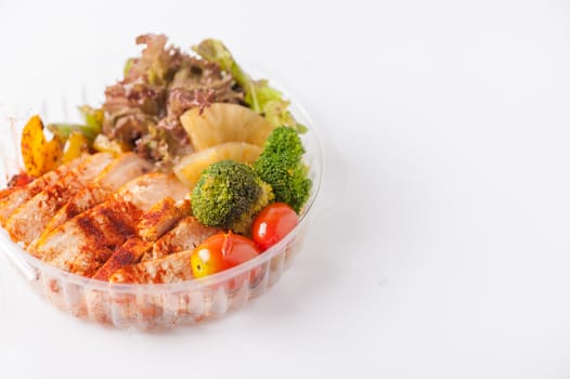 Roasted chicken with paprika powder cooked by clean food concept and salad in lunch box on white table