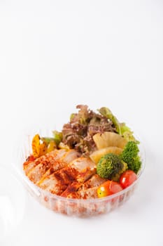 Roasted chicken with paprika powder cooked by clean food concept and salad in lunch box on white table