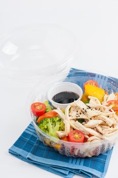Salad soba with vegetables and shred chicken cooked by clean food concept in lunch box on white table