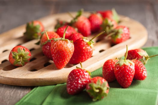 Strawberries on wood background in vintage style with low key scene.