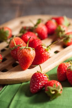 Strawberries on wood background in vintage style with low key scene.