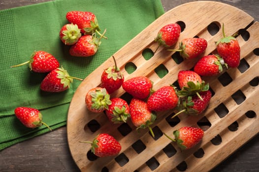 Strawberries on wood background in vintage style with low key scene.