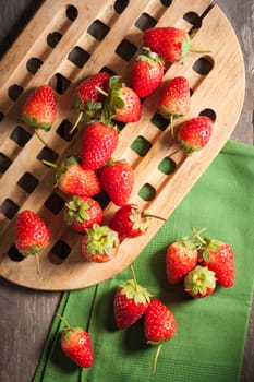 Strawberries on wood background in vintage style with low key scene.