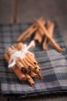 Cinnamon sticks on wood table with low key scene