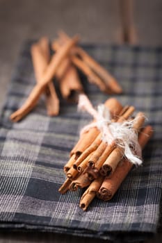 Cinnamon sticks on wood table with low key scene