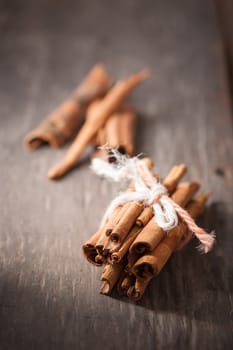 Cinnamon sticks on wood table with low key scene