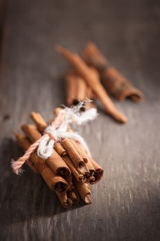 Cinnamon sticks on wood table with low key scene