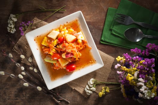 Thai mix fruit spicy dressed salad with low key scene